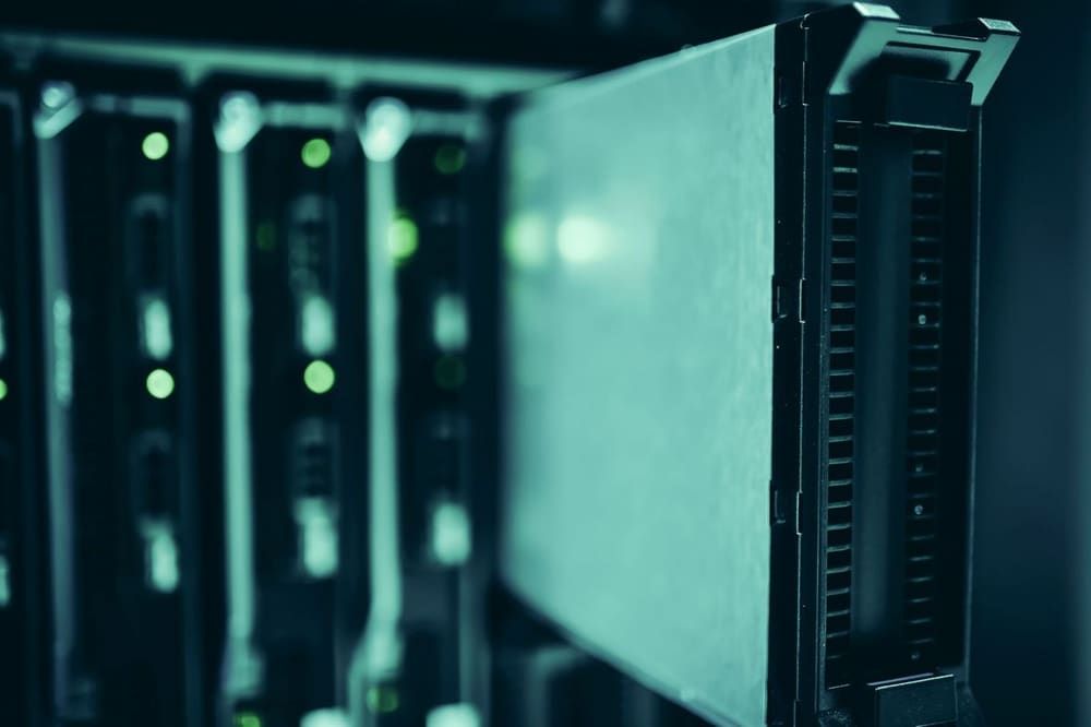Server racks with status lights glowing in a dark data centre
